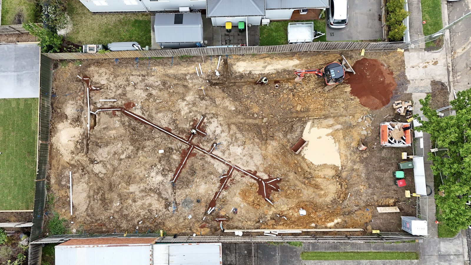 Aerial view of a residential block with the drainage layout set out across the soil.
