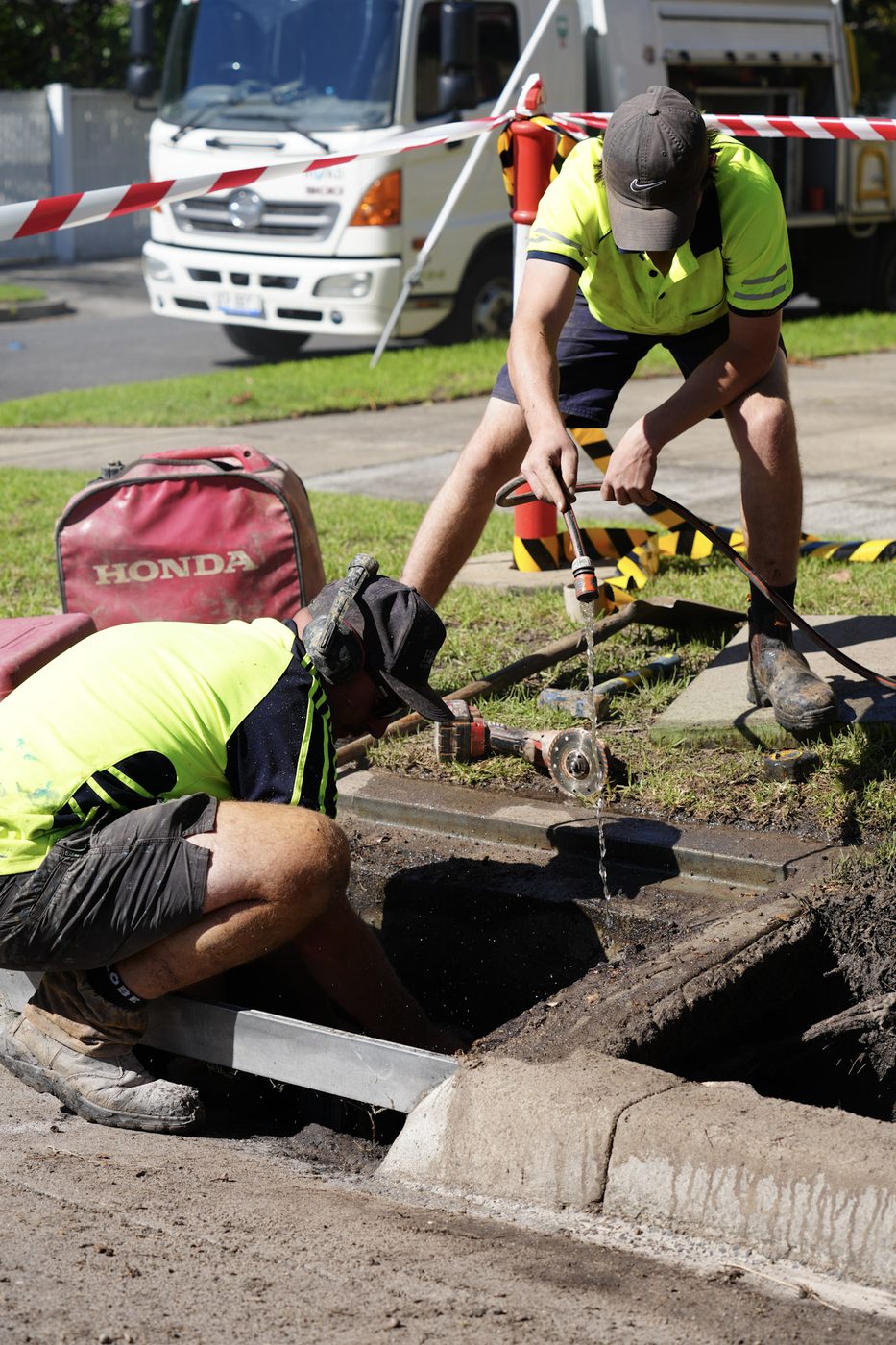 Hoad Drainage crew member working at a drainage access point where a camera is fed into the line.