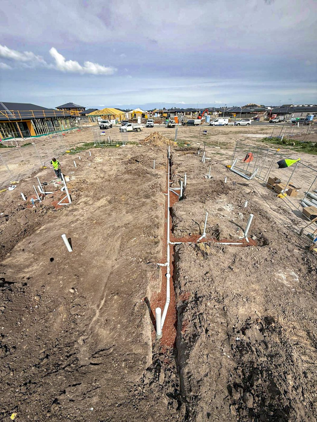 Drainage trench works across a residential estate development site.