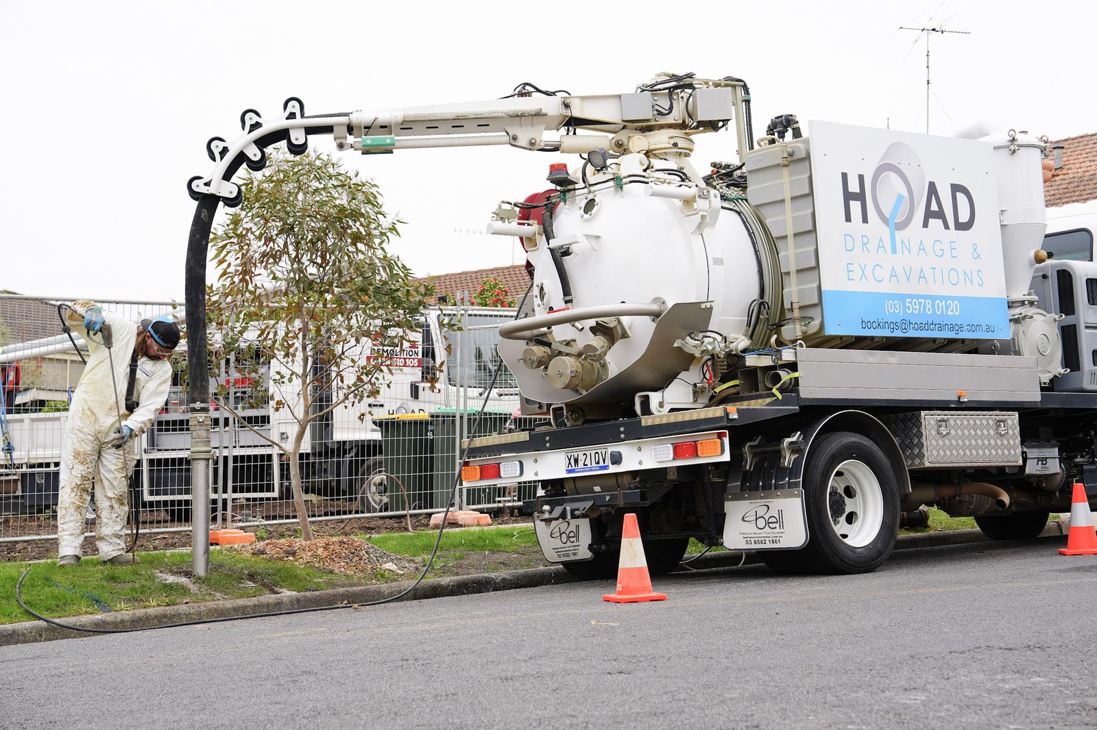 Hoad Drainage branded vacuum excavation truck parked on a suburban street.